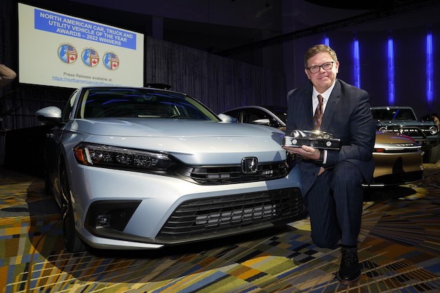 The 2022 Honda Civic was named 2022 North American Car of the Year in Detroit on January 11, 2022. Honda North Central Zone Manager Matt Almond displays the trophy for the award at the press conference.
